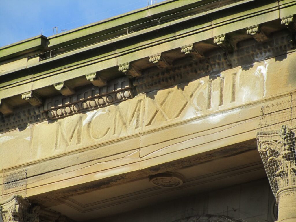 Stone carving on Clifton Street, above Hogarths