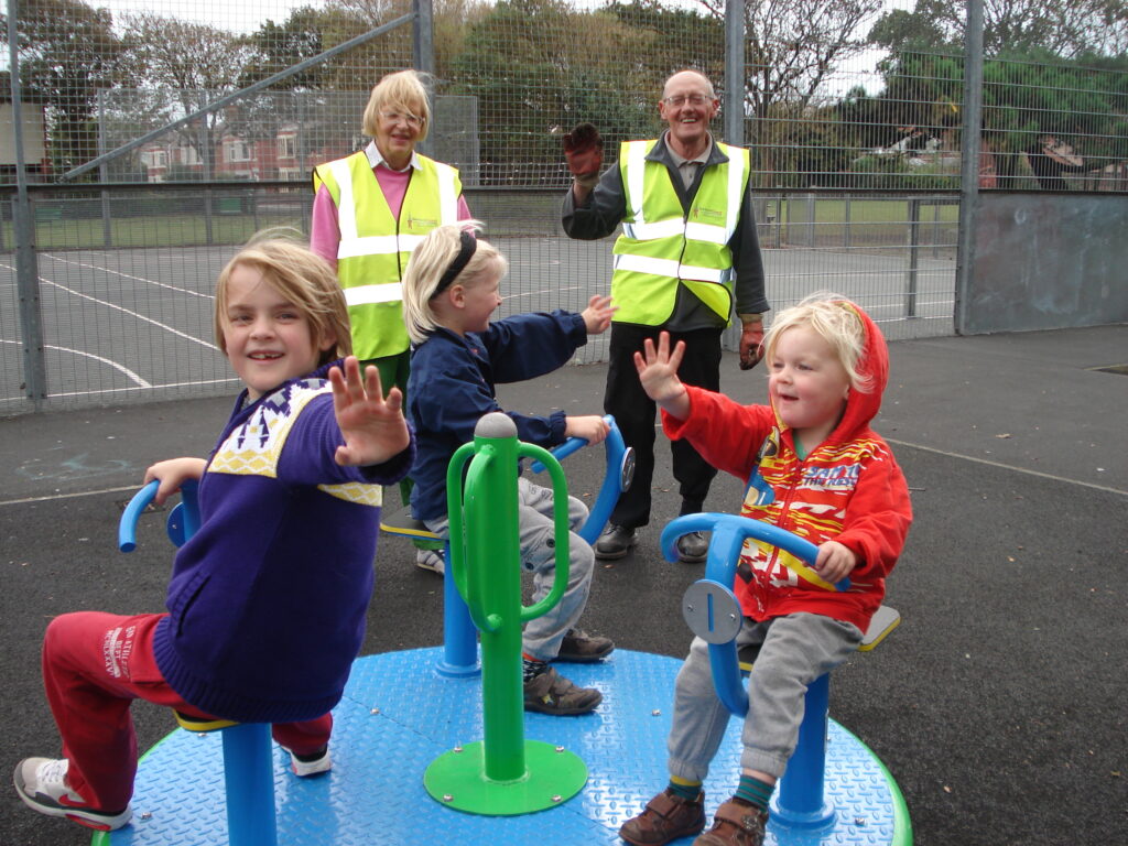 Local children enjoying the roundabout in Louie Horrocks Park