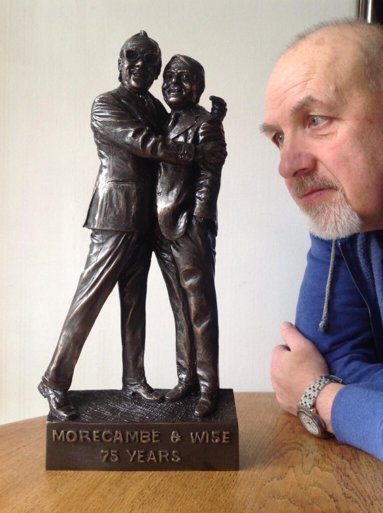 Sculptor Graham Ibbeson with the maquette of Morecambe and Wise
