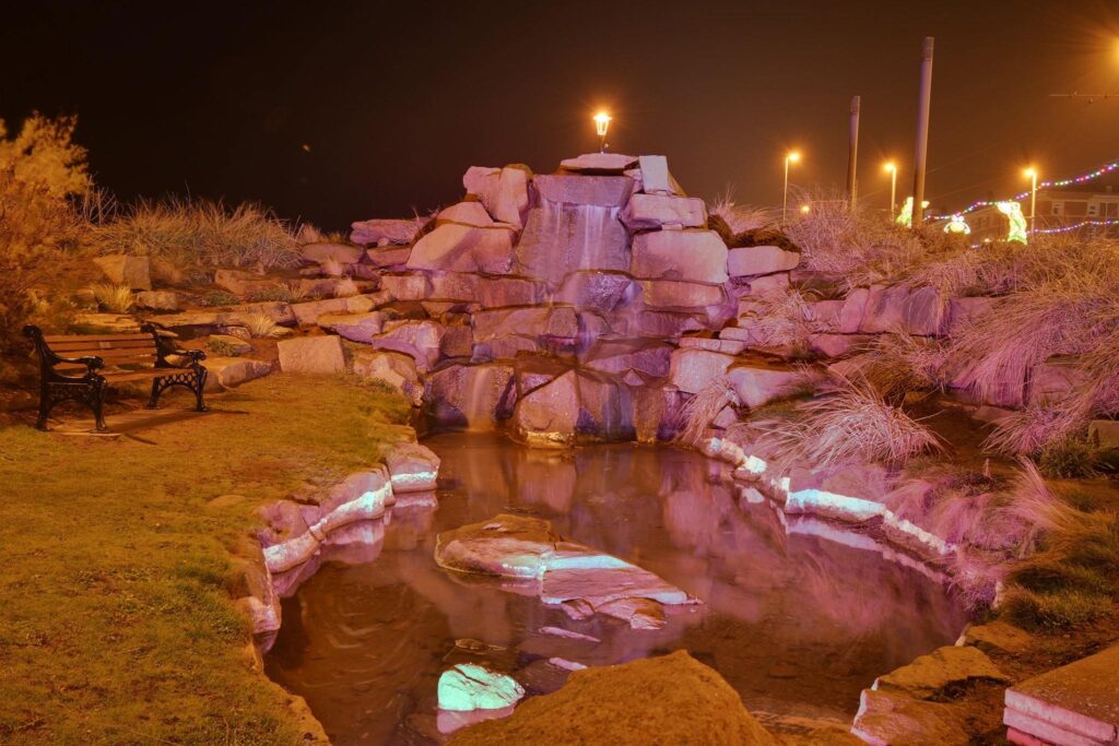 Waterfall lit up at night