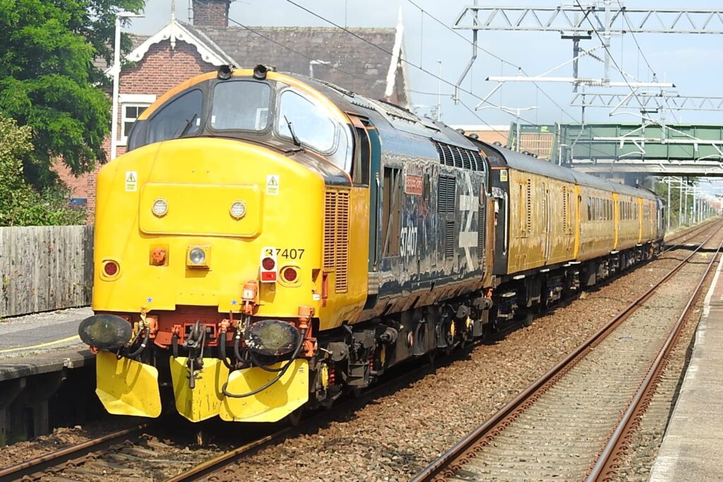 Having departed Blackpool North the train is powering through Layton with 'Blackpool Tower' pushing. Its heading for Blackburn, then after numerous reversals will eventually end up at Derby, its base. Photo: Barrie C Woods