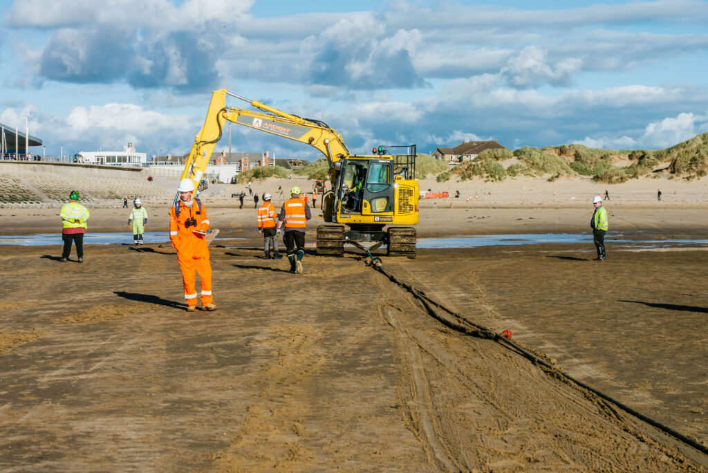 Diggers drag the cable to the connection point