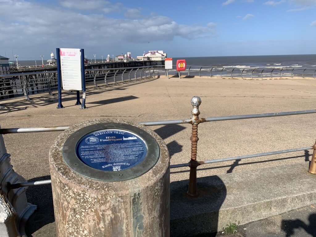 Blue plaque to HMS Foudroyant, against North Pier in Blackpool