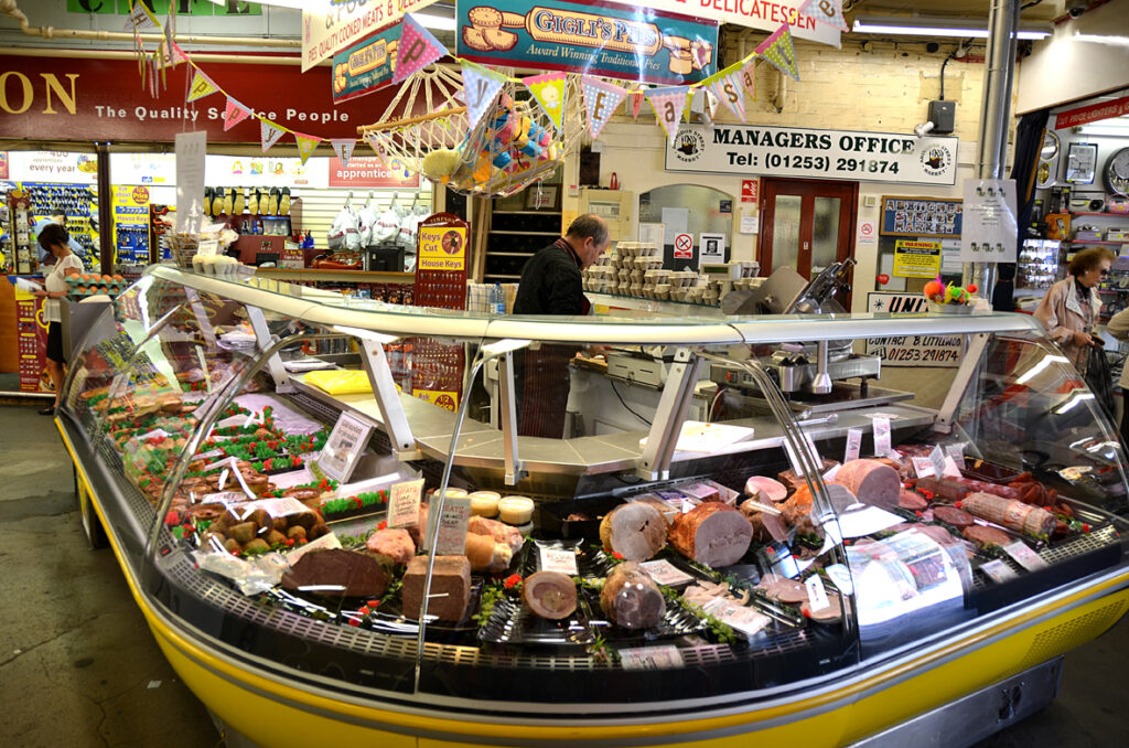 Deli stall with cooked meats and cheeses