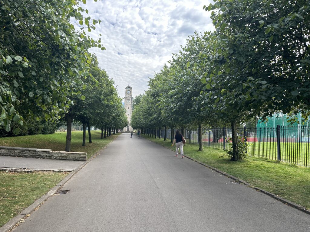 Tree lined walkway looking to the Cocker Clock Tower